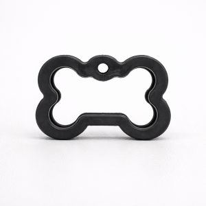 Bone Dog ID tag silencer on leather surface Bone Dog ID tag silencer on leather surface